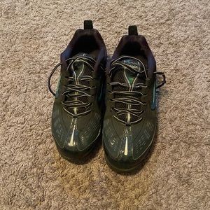 Very expensive and athletic shoes. Black, blue, and green.